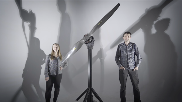 two people next to a large thrust stand